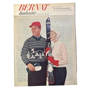 May include: A vintage Bernat Handicrafter Book No. 53 knitting pattern magazine featuring a cover illustration of two people in winter sportswear. The text reads: Bernat Handicrafter Book No. 53, the big book of ski and sports sweaters for men, women and youngsters.