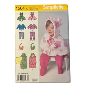 Simplicity 1564 Babies' Top, Pants, Capelet, Bib and one Size Blanket Wrap Uncut Sewing Pattern Sizes Newborn - 18 Months