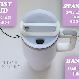 May include: White insulated mug with a gray lid and handle. The mug features a twist lid for easy use and a comfort grip handle. The mug is compatible with Stanley accessories.