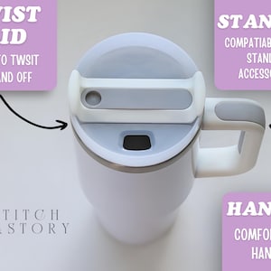 May include: White insulated tumbler with a twist lid and comfort grip handle. The lid is gray and white, and the handle is white with a gray grip. The tumbler is compatible with Stanley accessories. The text on the image says "Twist Lid", "Easy to Twist On and Off", "Stanley", "Compatible with Stanley Accessories", and "Handle, Comfort Grip Handle".