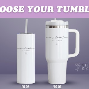 May include: Two white tumblers with black text that reads "mrs. stewart 11.22.2026" and a heart symbol. One is a 20 oz tumbler with a straw, and the other is a 40 oz tumbler with a handle. The text "CHOOSE YOUR TUMBLER" is at the top.