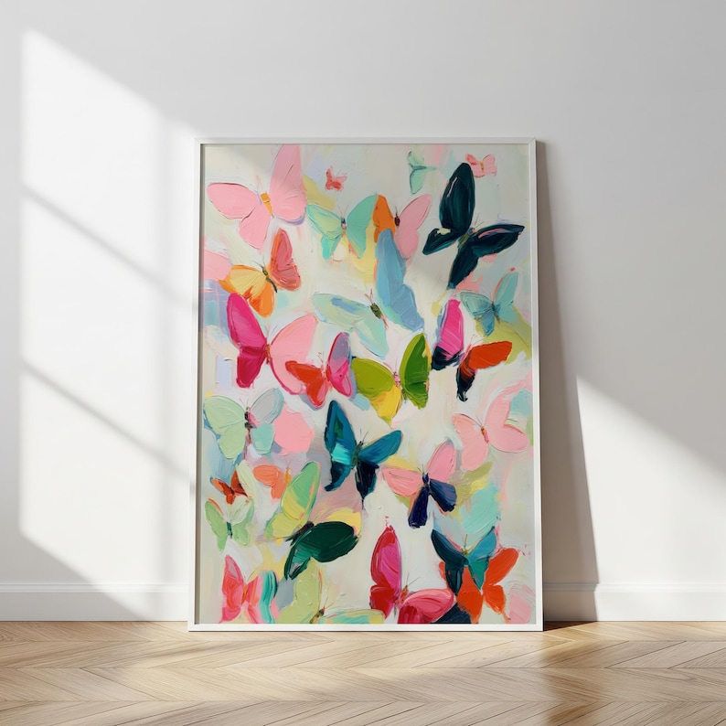 May include: A framed artwork showing a colourful painting of many butterflies in shades of pink, blue, green, and orange. The butterflies are painted with broad brushstrokes on a light background, creating a lively and vibrant composition.