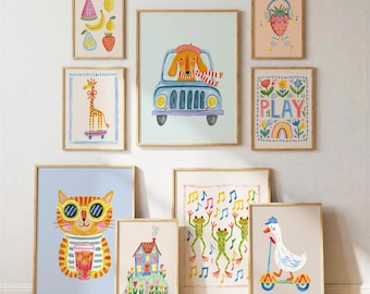 May include: A gallery wall set of nine framed art prints featuring colorful illustrations of a dog in a car, a giraffe on a skateboard, a cat with sunglasses, a goose on a scooter, dancing frogs, a house, fruit, a strawberry, and floral designs.