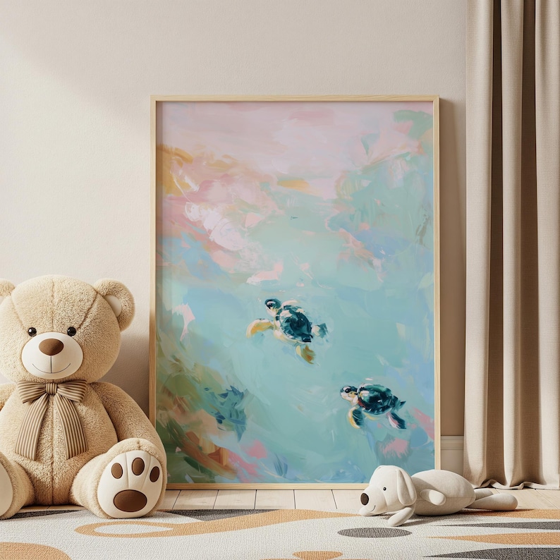 May include: An abstract art print featuring two sea turtles swimming in turquoise water. The artwork has a light wooden frame and is surrounded by a beige teddy bear, a white dog plush toy, and a patterned rug. The painting has soft pink and blue hues.