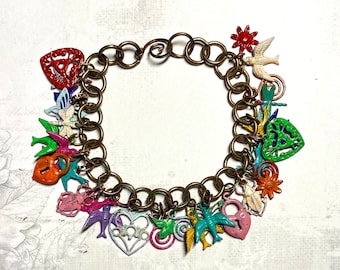 May include: A gold chain bracelet with a variety of colorful charms, including hearts, birds, flowers, and a lock. The charms are made of metal and have a vintage look.