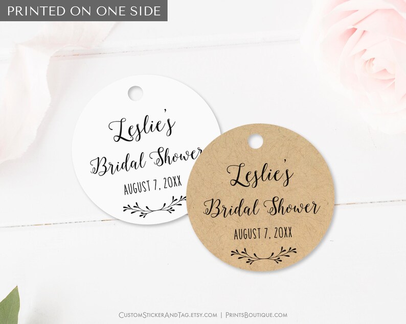 Bridal shower tags, round shape, personalized with your name and shower date. With your name at the top (in formal script font) and the vent date below (in all caps font) with a little branch drawing at bottom. Available in 6 cardstock colors.