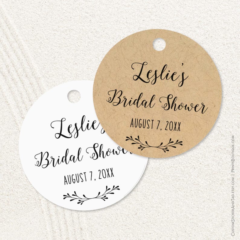 Bridal shower tags, round shape, personalized with your name and shower date. With your name at the top (in formal script font) and the vent date below (in all caps font) with a little branch drawing at bottom. Available in 6 cardstock colors.