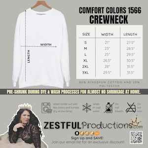 May include: A white Comfort Colors 1566 crewneck sweatshirt, shown on a hanger. The image includes a size chart with measurements in inches, and details about the fabric composition and care instructions. The text "Zestful Productions.com" is also visible.