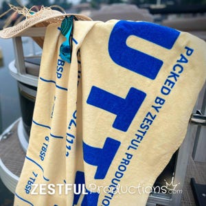 Retro Style Beach Towel Quirky Summer Essential Vintage Butter Pattern Design Cotton Backing Material Pool Beach Accessory Vacation Ready Item Large Size Options Blue Text Detail Premium Quality Construction Nostalgic Print Collection