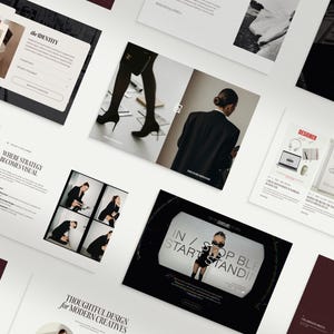 May include: An overhead shot of various design and marketing materials, including brochures and flyers. The materials feature images of people, text, and graphics. The color scheme is primarily black, white, and burgundy. Some text is visible, including "the IDENTITY" and "IN / STOP BLE START STANDING".