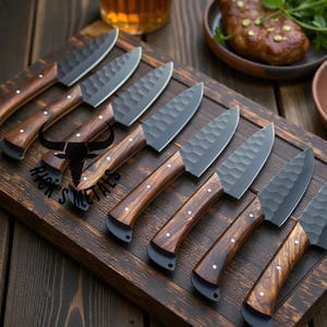May include: A set of eight kitchen knives with dark blades and wooden handles, arranged on a wooden cutting board. The handles have a curved design with a dark bolster and three white dot accents. The cutting board has a dark border and the text "RICK'S METALS".