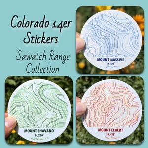 May include: A collection of round stickers featuring topographic maps of Colorado's Sawatch Range mountains. Each sticker displays a different mountain, including Mount Massive, Mount Shavano, and Mount Elbert, with their elevation in feet. The text "Colorado 14er Stickers" is also visible.