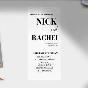 May include: A black and white wedding ceremony order of service for Nick and Rachel, taking place on October 26th, 2021 in St. Cloud, MN. The order of ceremony includes processional, welcoming words, reading, vows and rings, pronouncement, and recessional.