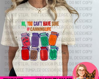 May include: Cream-colored t-shirt with a colorful graphic of canning jars filled with various foods. The text reads "No, You Can't Have Some #CanningLife". Below the graphic is the text "Tennessee Tumbler Designs".