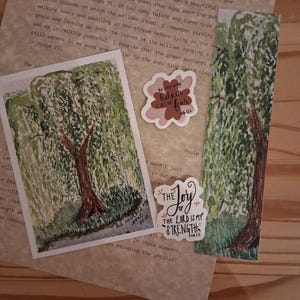 May include: A collection of stationery items including a rectangular watercolor painting of a willow tree, a tall bookmark with a matching willow tree illustration, and two die-cut stickers with text reading He is my helper and The joy of the Lord is my strength.
