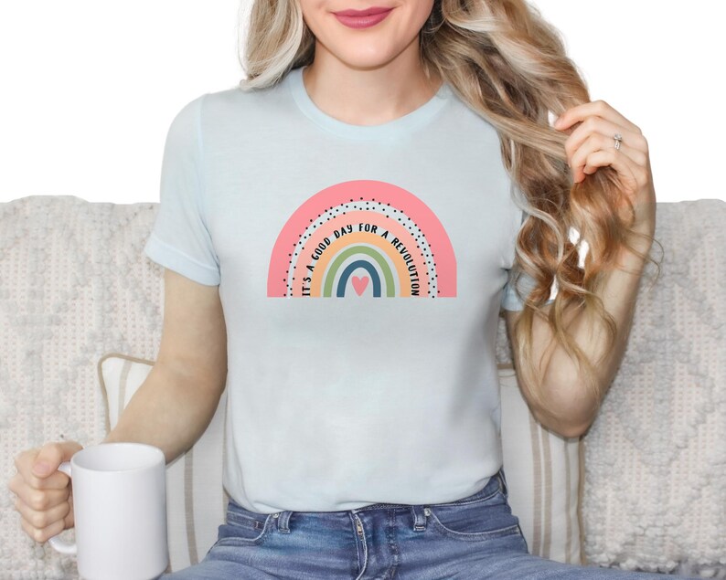 May include: A light blue t-shirt with a rainbow graphic and the text "It's a good day for a revolution".
