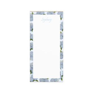 May include: A rectangular notepad with a light blue floral border featuring hydrangea blooms. The word "Sydney" is written in a script font at the top. The notepad has a white interior for writing.