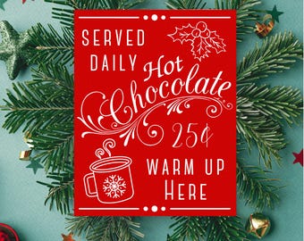 May include: A red sign with white text that reads "Served Daily Hot Chocolate 25¢ Warm Up Here". The sign is decorated with a holly sprig and a steaming mug of hot chocolate.