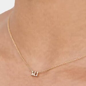 May include: A gold chain necklace with a small pendant featuring the number 111 with a single diamond in the center.