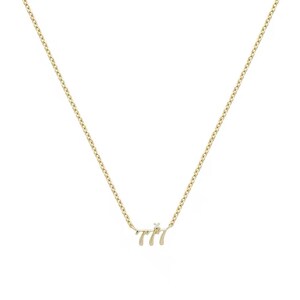 May include: A gold chain necklace with a pendant that says "777" with a small diamond in the center.