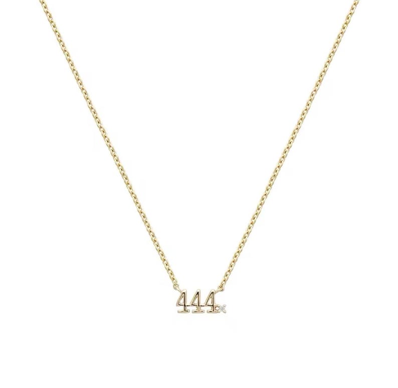 May include: A gold chain necklace with a pendant featuring the number 444 with a small diamond accent.