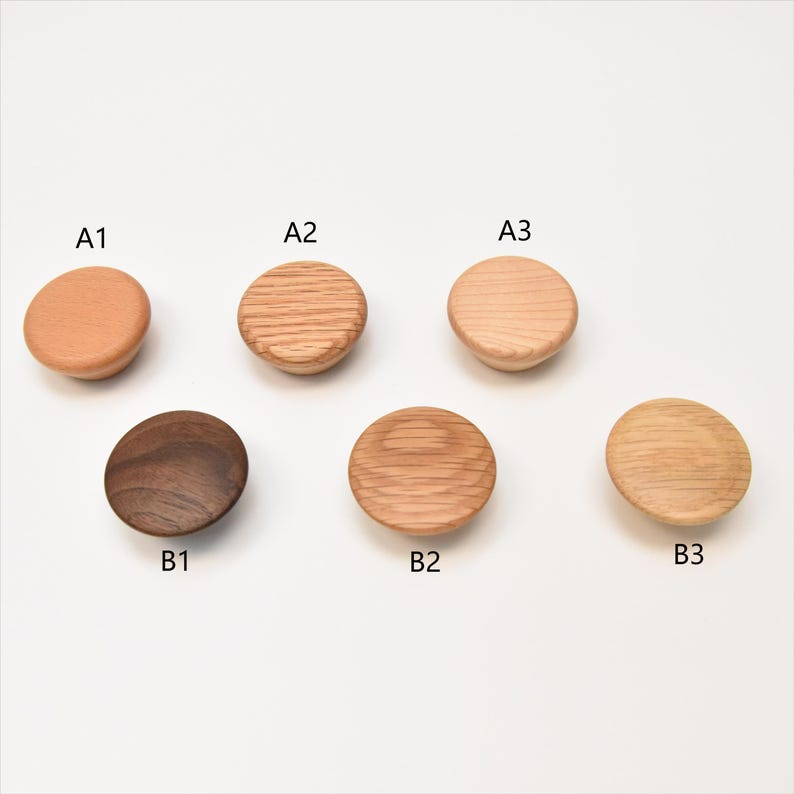 May include: Six wooden knobs in different shades of brown. The knobs are labeled A1, A2, A3, B1, B2, and B3.