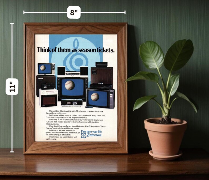 May include: A framed advertisement for Emerson televisions featuring a variety of televisions with a baseball theme. The ad copy reads "Think of them as season tickets." and "Fine tune your life. Emerson."