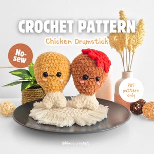 May include: Crochet pattern for a no-sew chicken drumstick amigurumi. The pattern is available as a PDF download only. The image shows two finished crochet chicken drumsticks, one with a red sauce topping.