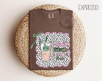 May include: Brown t-shirt with a graphic of an iced coffee cup and the text "Maybe Iced Coffee is addicted to me." The design includes a green bow and a black and white dalmatian print.