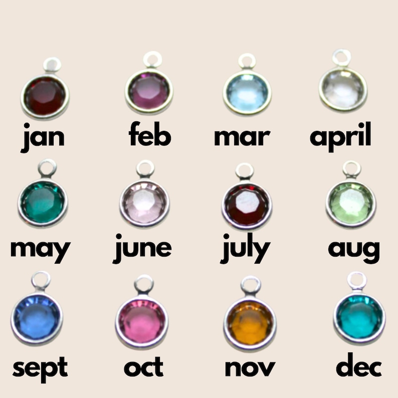 The image shows twelve small, silver round birthstone charms, each labeled with a month from January to December. Each charm has a different colored gemstone corresponding to the traditional birthstone for that month.