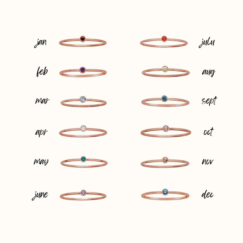 Puede incluir: Doce delicados anillos de oro, cada uno con una peque&ntilde;a piedra preciosa. Los anillos est&aacute;n dispuestos en dos filas de seis, con los meses del a&ntilde;o etiquetados encima de cada anillo. Las piedras preciosas son roja, p&uacute;rpura, azul, blanca, verde, rosa, naranja, amarilla, azul, rosa, azul y azul.