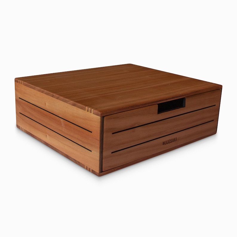 May include: A wooden box with a drawer, the drawer has a black handle and the box is labeled "WOODSACA"
