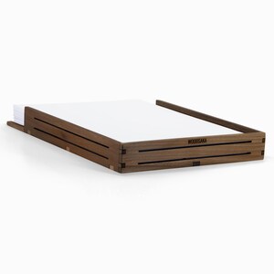 May include: A wooden desk organizer with a dark brown finish. The organizer has two compartments and the text "WOODSAKA" is engraved on the front.