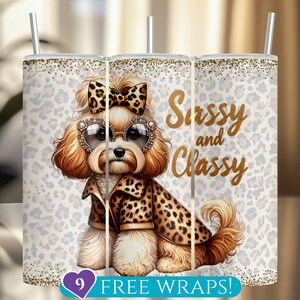 May include: A tumbler featuring a cartoon dog with a bow, sunglasses, and a leopard print coat. The words "Sassy and Classy" are written in gold script. The background has a white and gray leopard print pattern.