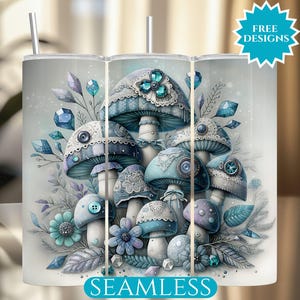 May include: A white tumbler with a fantasy illustration of blue and white mushrooms with detailed patterns. The design includes floral accents, sparkling gems, and the text "FREE DESIGNS" and "SEAMLESS". The tumbler has a silver straw.