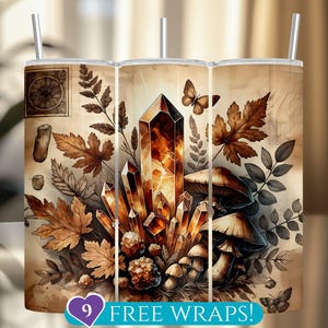 May include: A stainless steel tumbler with a wraparound design featuring a large crystal, mushrooms, and autumn leaves in shades of brown and orange. The text "9 FREE WRAPS!" is at the bottom. Includes a straw.