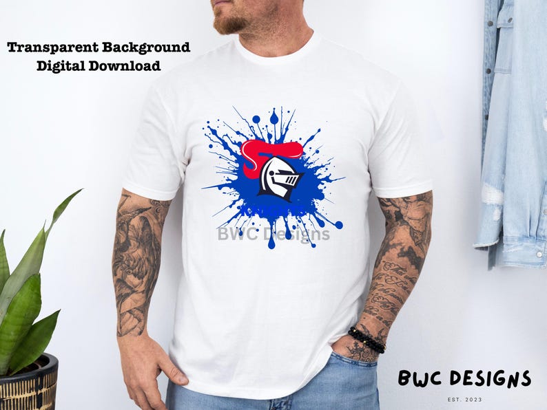 May include: White t-shirt with a blue and red knight helmet graphic in a blue paint splatter design. The text "BWC Designs" is below the graphic.