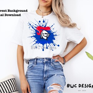 May include: A white t-shirt with a blue and red knight helmet graphic in a blue paint splatter design. The text "BWC Designs" is visible on the shirt.