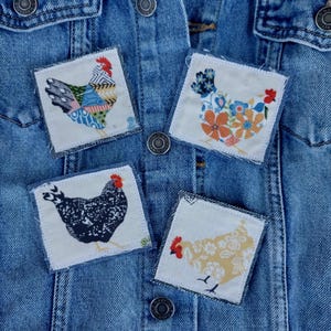 May include: A denim jacket adorned with four square fabric patches featuring colorful chicken designs. The patches showcase various patterns and colors, including floral and patchwork styles, with red combs and black feet.