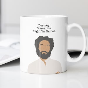 May include: White ceramic mug featuring a stylized illustration of a man with a beard and glasses. The mug has the text "Destroy. Dismantle. Engulf in flames." printed in black above the illustration.