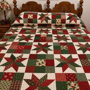 May include: A patchwork quilt featuring a repeating pattern of eight-pointed stars in shades of red, green, and cream. The design incorporates various fabric textures including plaid, snowflake prints, and holly motifs, finished with a quilted texture.