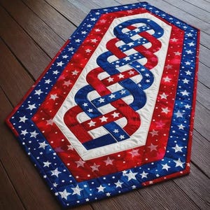 May include: A patriotic table runner with a red, white, and blue color scheme. The design features a central intertwined pattern of red and blue ribbons, bordered by a white section and a star-studded blue and red frame. The runner is approximately 30 inches long.