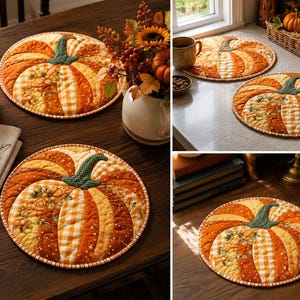 May include: A round quilted fabric mat featuring a pumpkin design composed of various orange, yellow, and white patterned fabric segments. The pumpkin has a dark green textured stem and is finished with a matching orange and white checkered border.