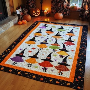 May include: A handmade Halloween quilt featuring a repeating pattern of witch figures with colorful skirts and black hats. The quilt has an orange border and a black patterned edge, perfect for seasonal decor.