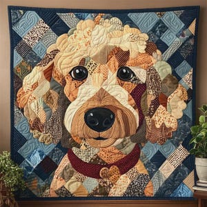 May include: A handcrafted quilt featuring a detailed portrait of a dog. The dog's face is composed of various fabric patches in shades of beige, brown, and cream, with a dark red collar. The background is a patchwork of blue and patterned fabrics.