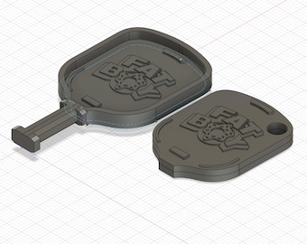 May include: A gray plastic key chain with a donut and the words "FAT BOY" on it. The key chain is in two parts, one with a key ring and the other with a flat, rectangular shape.