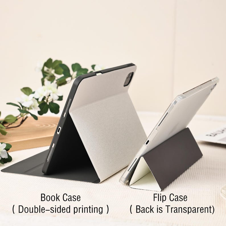 May include: Two tablet cases are displayed. One is a book case with double-sided printing, and the other is a flip case with a transparent back. Both cases are in a neutral color palette, with a black frame and a light-colored interior.
