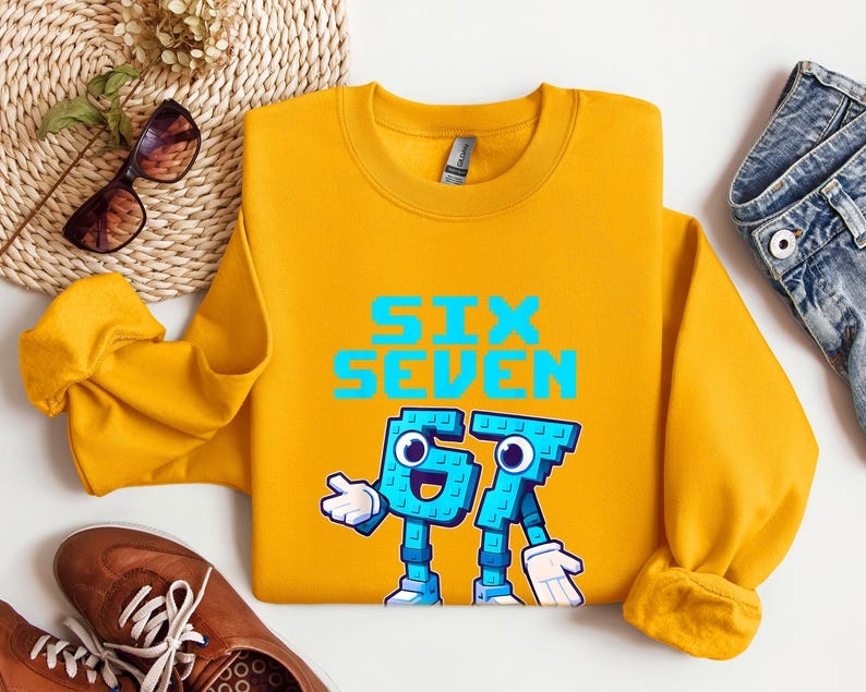 a yellow sweatshirt with a graphic design, a pair of jeans, sunglasses, and a pair of brown shoes, all laid out on a white background.