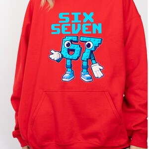 A red hoodie with a graphic design featuring a blue character and the text "Six Seven" printed on it.