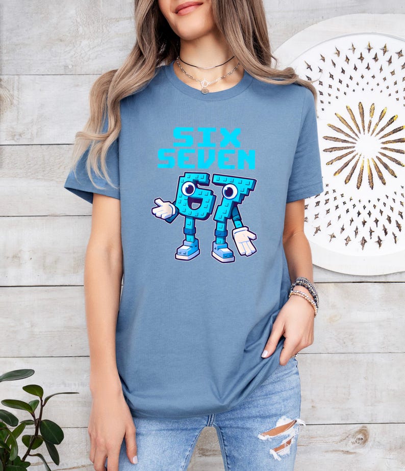 A woman wearing a blue t-shirt with a graphic design of a blue character and the text "Sex Seven" printed on it.